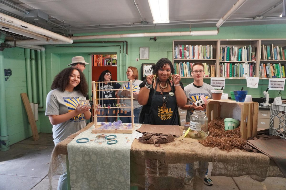 Horticulture kids selling jewelry, tote bags, and painted bowls to the guests.