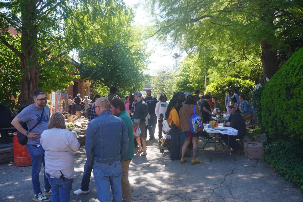 Guest exploring Ag Alley to see the many tables students and staff at Saul set up